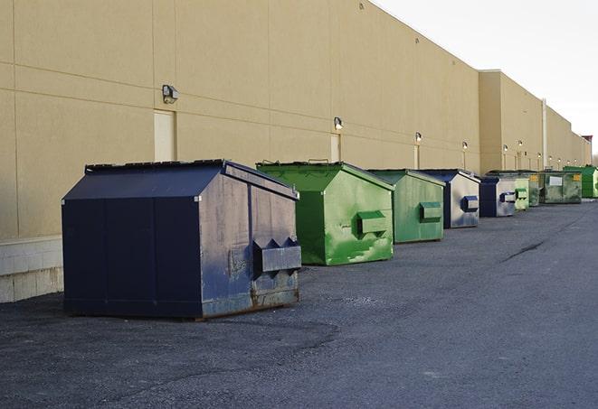 a group of construction workers taking a break near a dumpster in Claremont CA